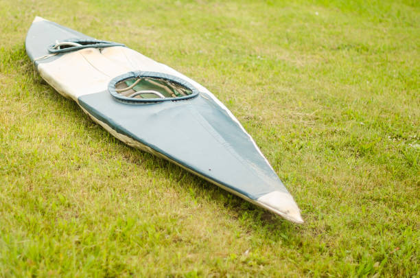 istock An old kayak is placed in the green grass 1332433694