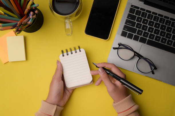 istock Female designer holding pen and notebook. 1332435941