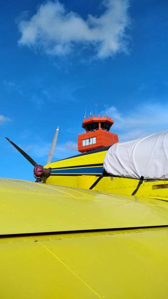 istock Yellow airplane with oren tower 1332436672