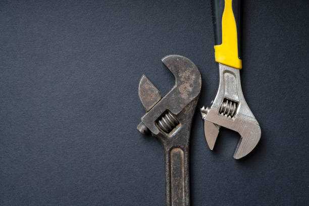 istock Old rusty wrench and new chrome wrench on a dark background 1332440686