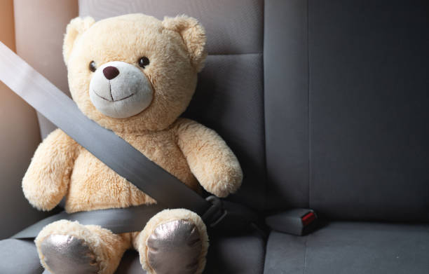 istock Teddy bear wearing seat belt for safety 1332440900