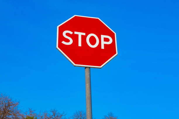 istock Red stop sign in city close up 1332442758