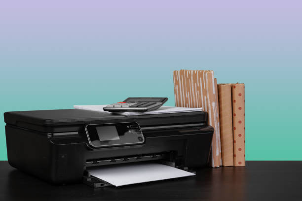 istock Home laser printer on desk against green background 1332442803