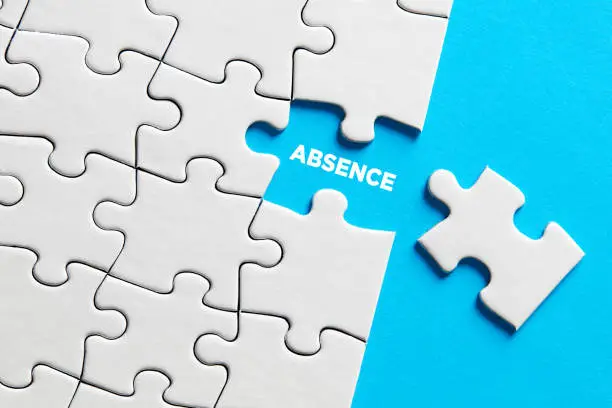 The word absence on missing puzzle piece. Business concept.