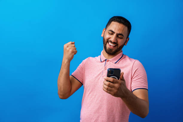 istock Portrait of arab man using his smartphone in studio 1332444427