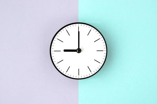 istock Clock on purple and light blue background, morning and night time image 1332446683