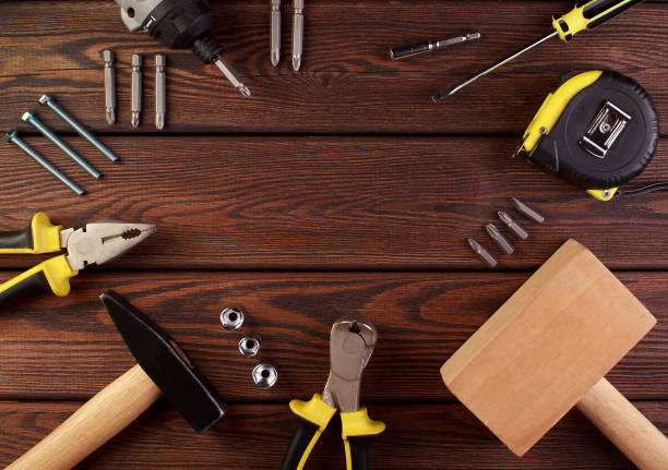 istock Tools worker, hammer, screwdriver, pliers on a wooden background, top view 1332449298