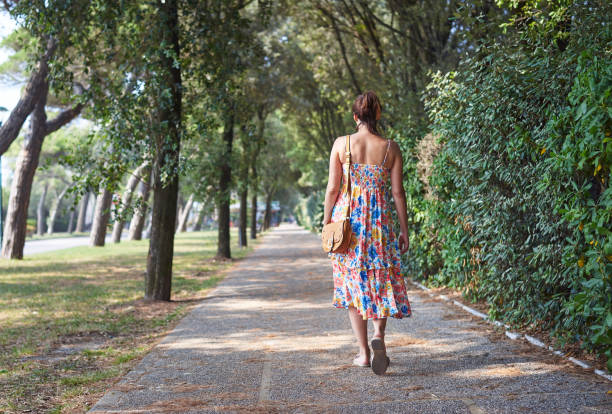 istock Woman walking on street 1332451773