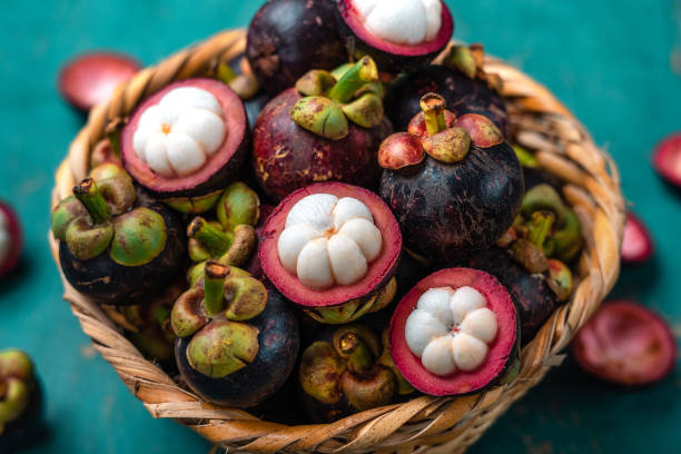 istock Mangosteen fruit on light blue wooden background 1332453167