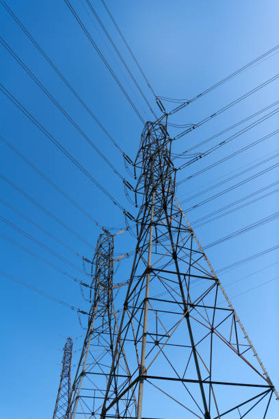 istock voltage transmission on electric tower. high-voltage on urban backdrop. powerful substation 1332454675