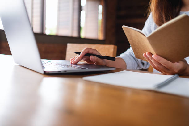 istock a woman working on paperwork and laptop computer in office 1332456352