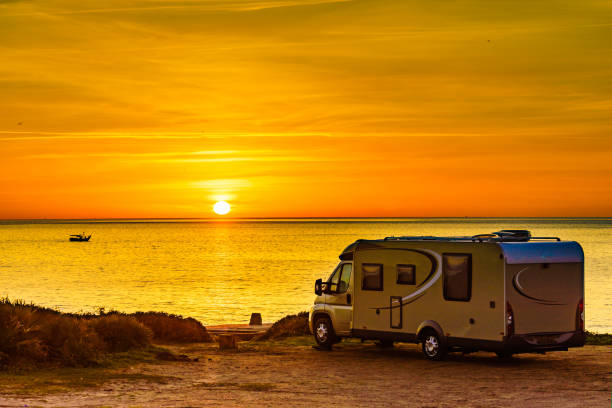 istock Camper vehicle on beach at sunrise 1332456941