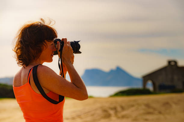 istock Tourist with camera on spanish coast. 1332457800