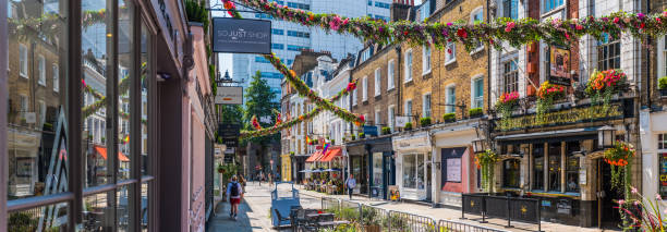 london flower garlanded shopping street in summer panorama covent garden - london store fotografías e imágenes de stock
