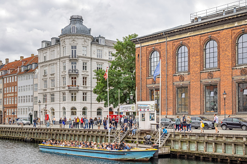 Sightseeing boat in a old harbor, which despite its name - New Harbor - is the oldest part of the harbors in Copenhagen and a popular tourist spot