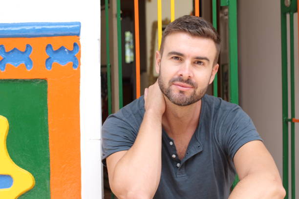 istock Good looking young man smiling in front of home 1332463420