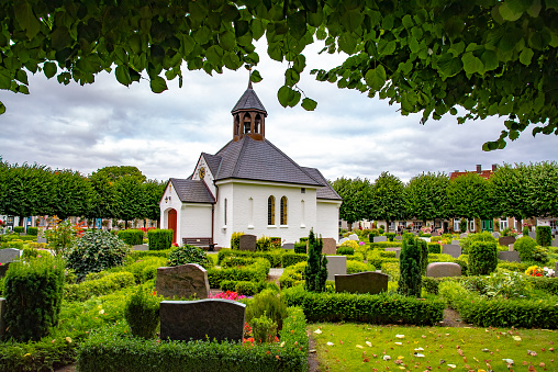 The small chapel and graveyard in Holm, which is an old fishing village, founded around 1000 a.c. at the Schlei, formerly an island now connected to the town of Schleswig, Germany on July 15,2016