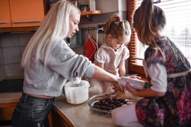 istock Small Female Children Learning About Dessert Making From Single Mother 1332465094