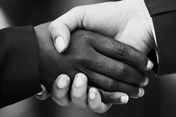 istock Closeup image of two women shaking hands 1332468737