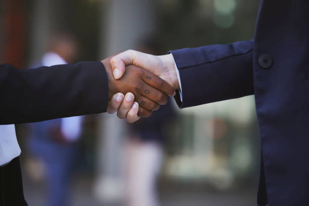 istock Closeup image of two women shaking hands 1332468798