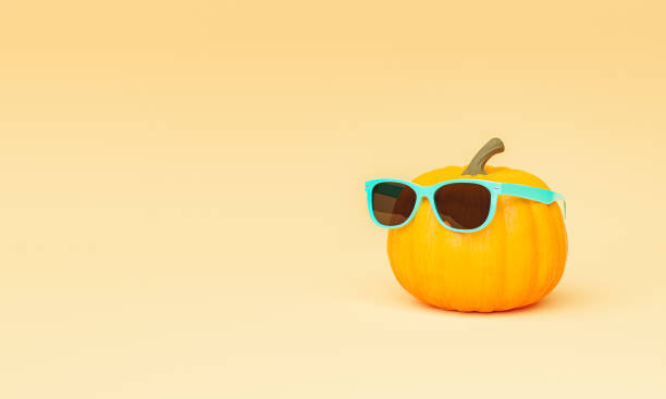 istock pumpkin with turquoise sunglasses on minimalist beige background 1332469215