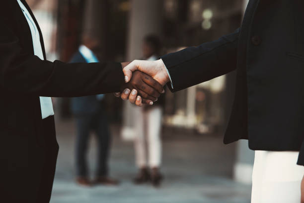 istock Closeup image of two women shaking hands 1332471309