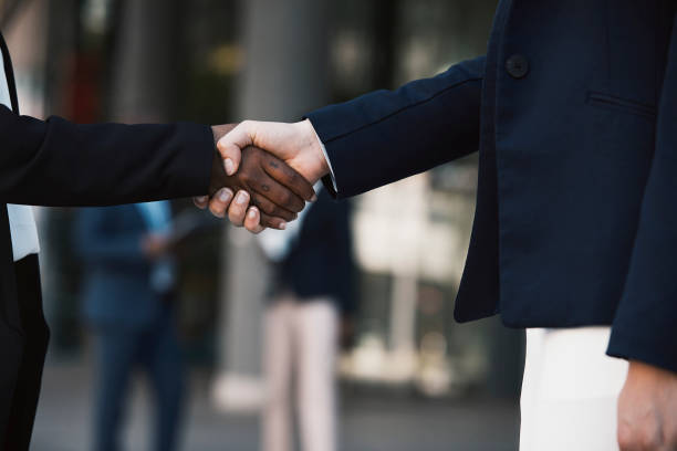 istock Closeup image of two women shaking hands 1332471380