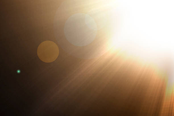 Golden sunlight rays against a dark backgrounds