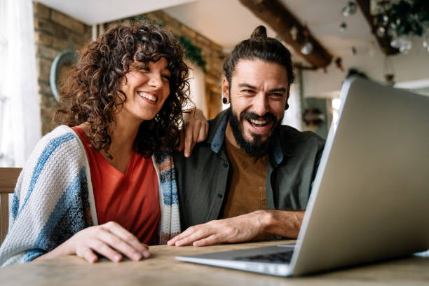 istock Couple relaxing together at home with computer pc having fun 1332472546