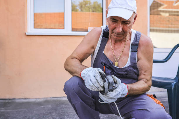 istock Man using an angle grinder to cut and repair 1332474843