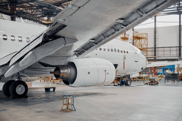 istock Professional plane expluatation service in big hangar 1332475029