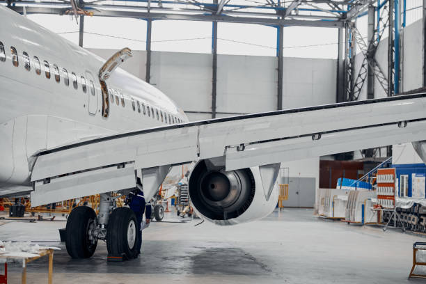 istock Professional plane expluatation service in big hangar 1332475031