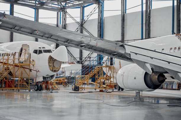 istock Professional plane expluatation service in big hangar 1332475035