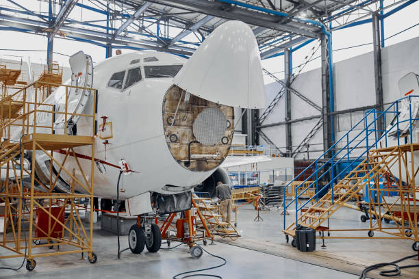 istock Professional plane expluatation service in big hangar 1332475050