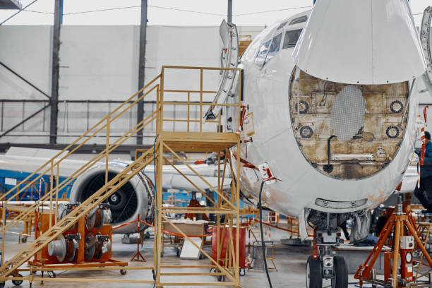 istock Professional plane expluatation service in big hangar 1332475054