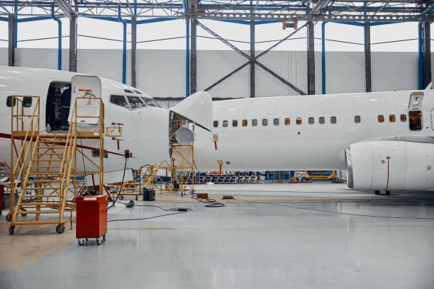 istock Professional plane expluatation service in big hangar 1332475059