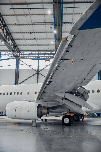 istock Professional plane expluatation service in big hangar 1332475064