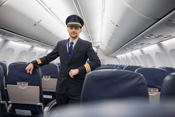 istock Happy confident caucasian pilot in airplane salon 1332475070