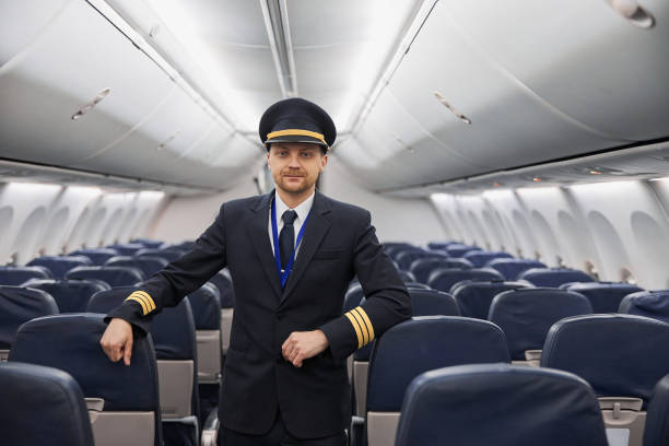 istock Happy confident caucasian pilot in airplane salon 1332475072