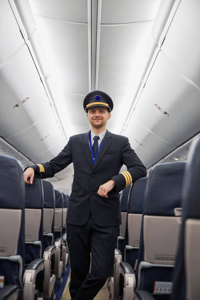 istock Happy confident caucasian pilot in airplane salon 1332475075