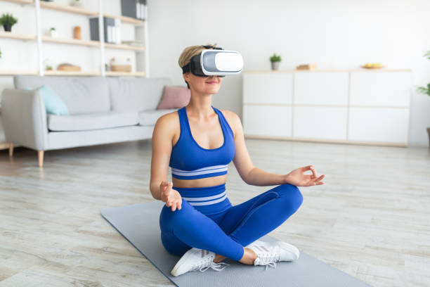 istock Woman in VR headset sitting in lotus pose, meditating 1332475285