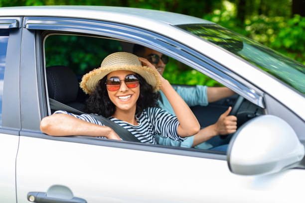 istock Ecstatic millennial husband and wife having car trip 1332475902