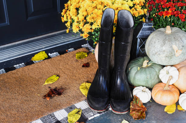 istock Rain Boots and Fallen Leaves on Front Porch Decorated for Autumn 1332476476