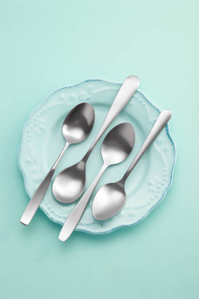 istock stainless spoon in ceramic dish on pastel background 1332476584