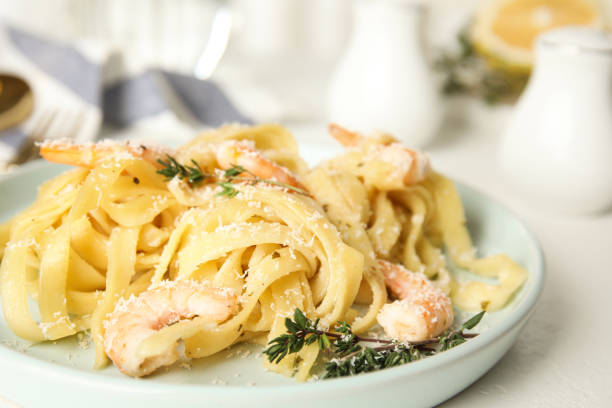 istock Delicious pasta with shrimps on white table, closeup 1332476745