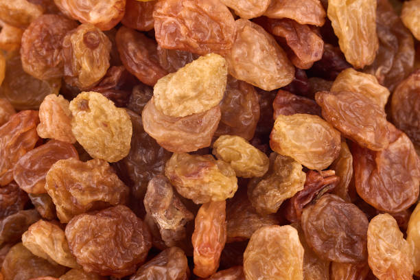 istock Yellow raisins background texture, copy space. Dried grape texture. Delicious background or wallpaper. Abstract food textures. Healthy food organic nutrition. Top view, flat lay 1332476826