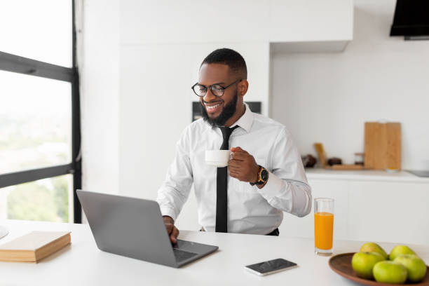 istock African American man using laptop drinking coffee 1332477101