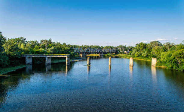 istock Ancient ruined stone bridge and serene river 1332477255