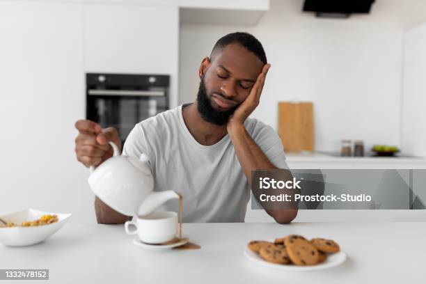 Black Man Pouring Coffee Away From Cup Spilling Hot Drink Stock Photo - Download Image Now