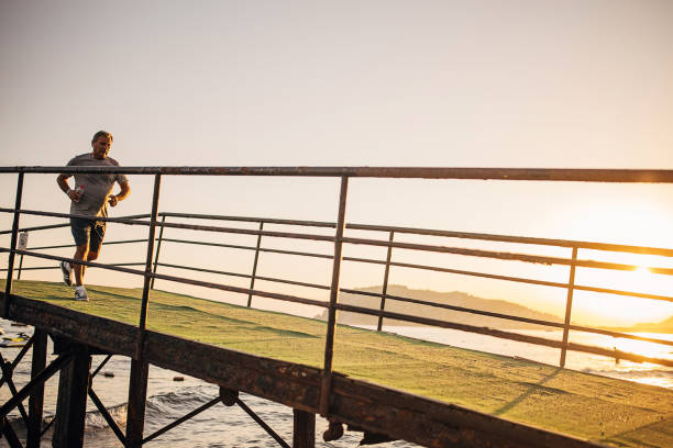 istock Senior man jogging on a pier 1332478238